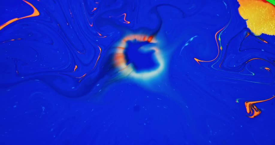 An abstract liquid like paint changing colors from blue to orange and neon green and yellow