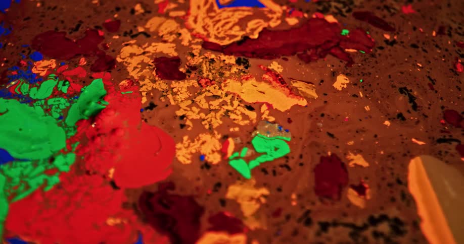 Colorful bright liquid ink over a surface forming chaotic psychedelic patterns