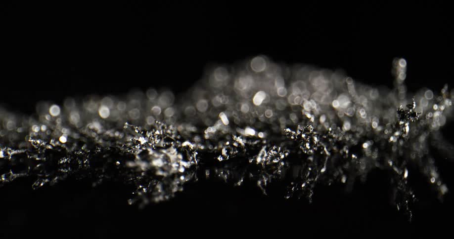 Black white and silver colors that look like ice crystals moving