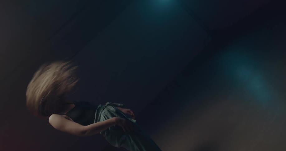 A woman is dancing in an empty room