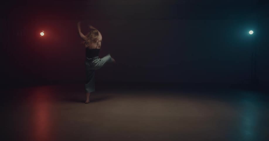 A young woman dancing on a stage