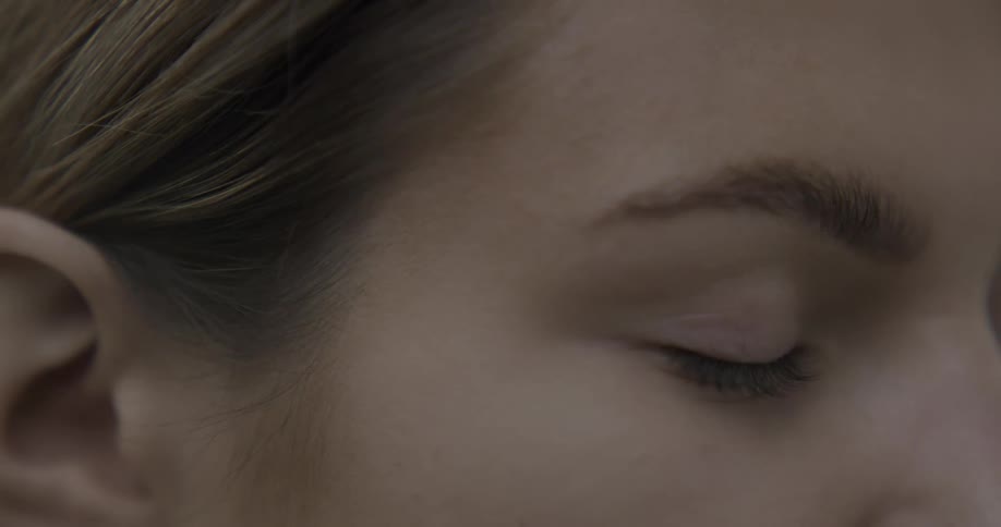 A woman opens her eye