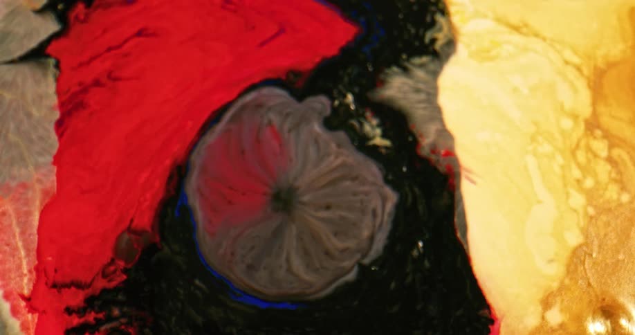 A round mass expands through the surface between orange and yellow