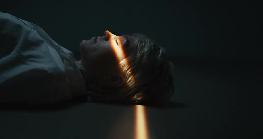 A woman is laying on the ground indoors