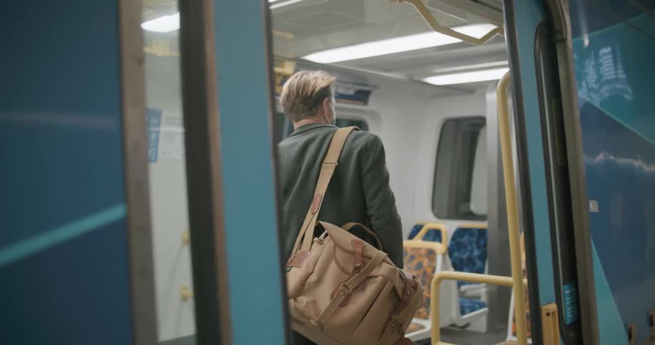 People wearing face mask board and exit train at train station