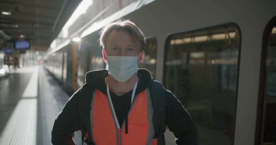 A public transit worker posing