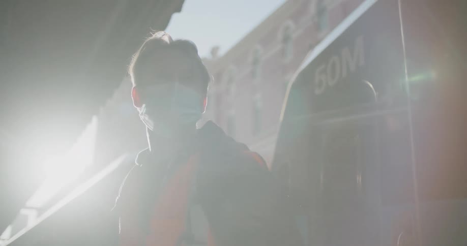 A man standing in front of public transit