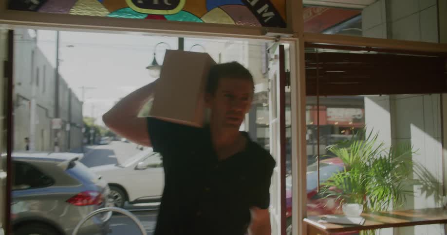 A man bringing a box into a building