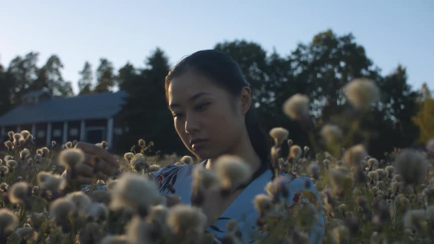 Female staring at flowers thinking deeply