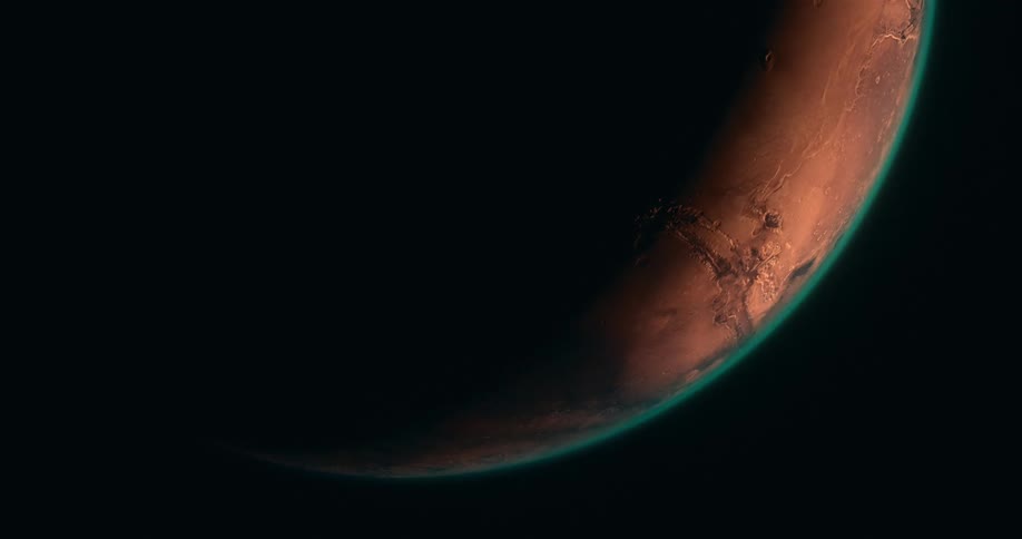 An orange rust colored orb with green ring against a black background