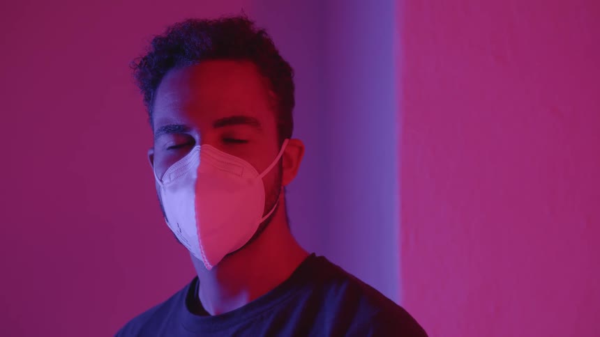 A man putting a mask on and off