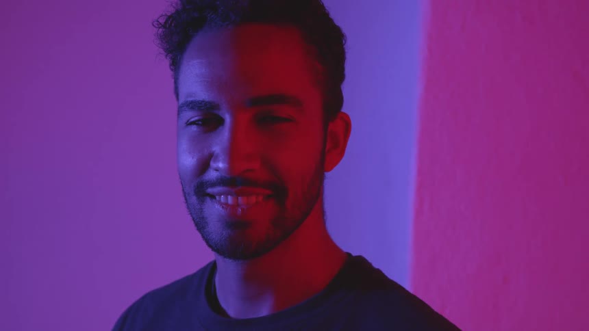 A man smiling and looking at a camera