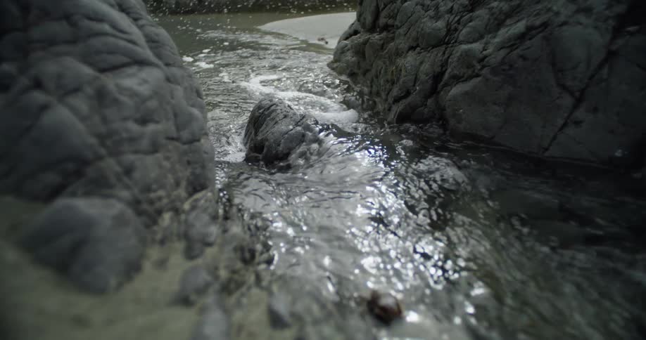 A stream moving around jagged rocks