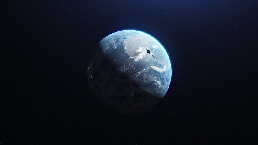 Planet earth rotating as the shadow moves over the globe and a spacecraft flies by