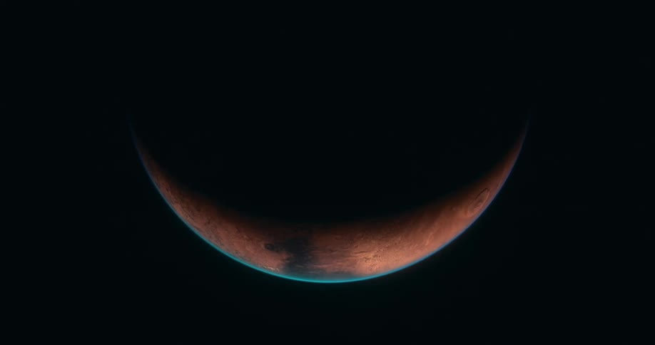 A red planet in space orbiting slowly