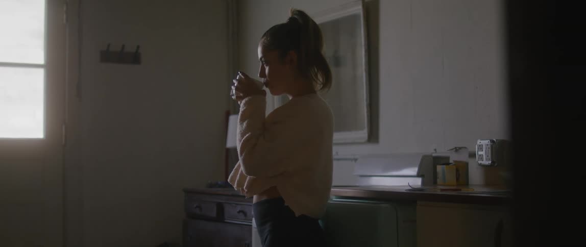 A woman drinking from a coffee cup