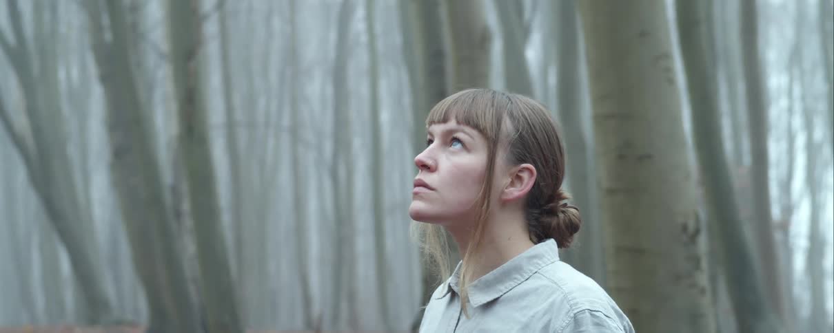 A woman standing in a forest