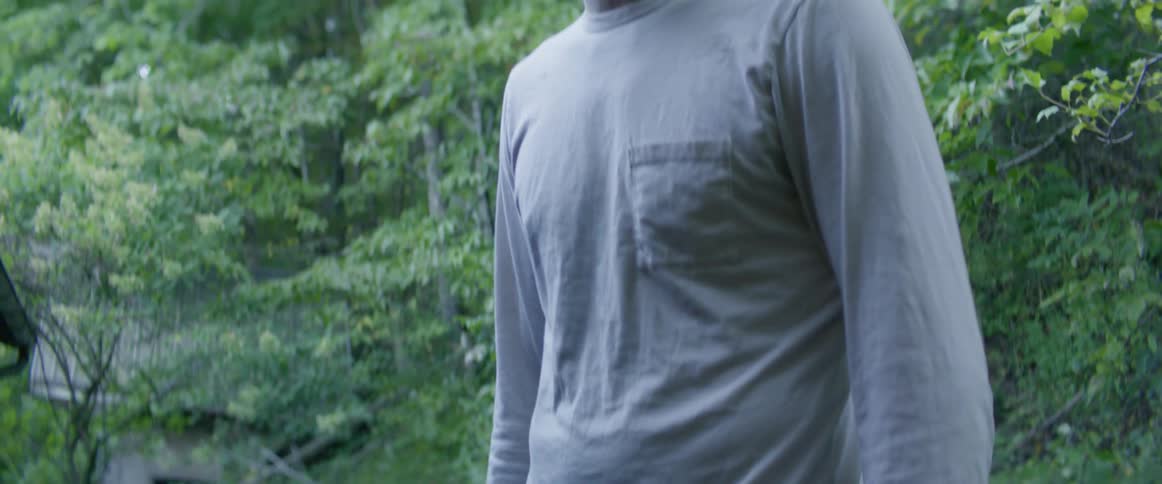 Man and woman arguing and shouting at each other next to a forest area
