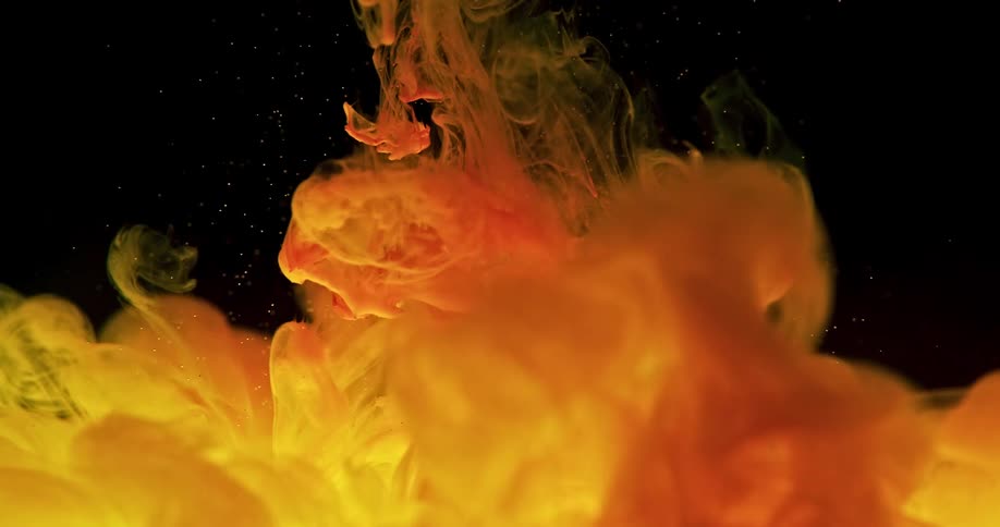 Black background with orange and cream liquid being poured
