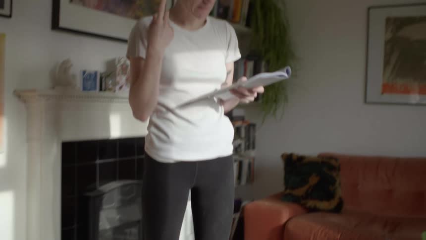 A woman reading and walking back and forth