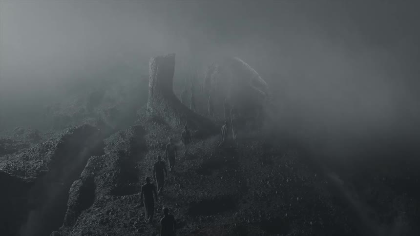 People walking in a landscape with soil and fog