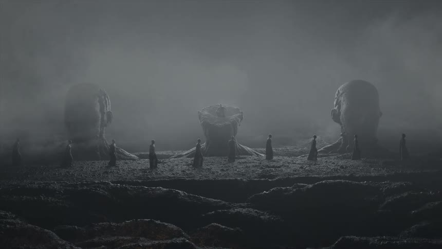 Surreal dreamlike footage of a line of people walking in front of giant head sculptures in the mist