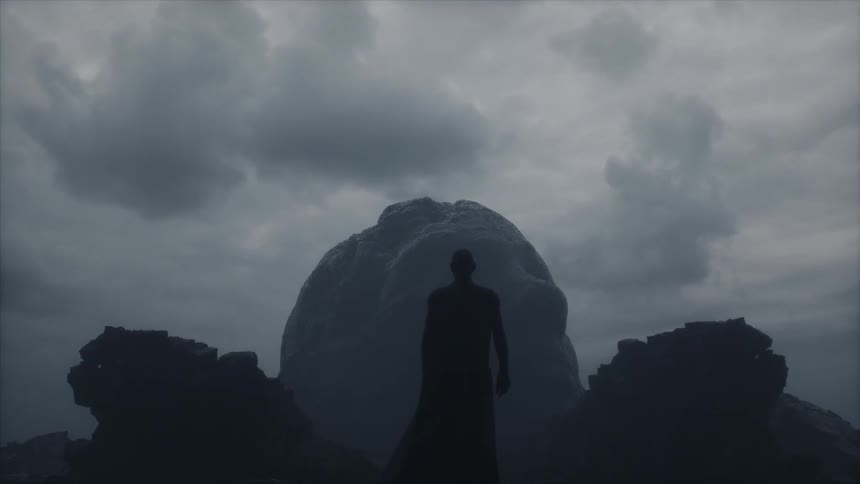 A man standing in front of a rock