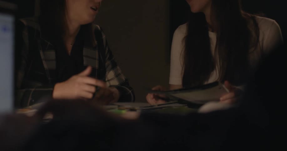 Two women talk together at the table