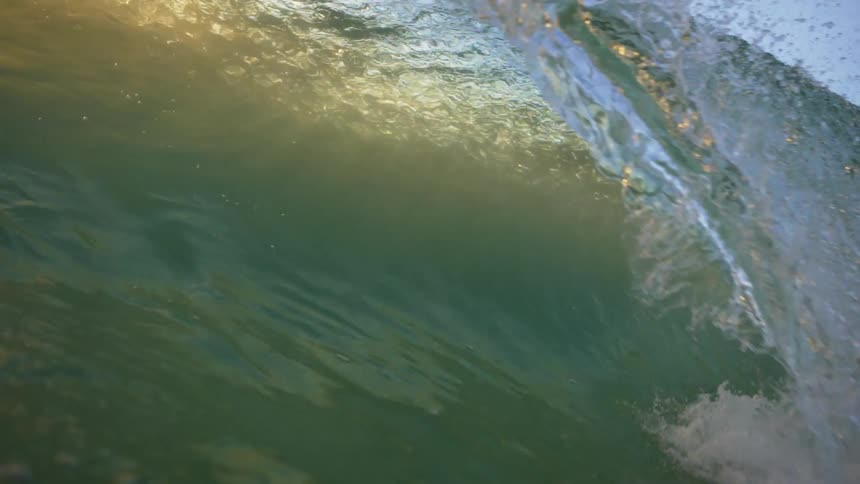 A wave crashing down and the camera going under the water