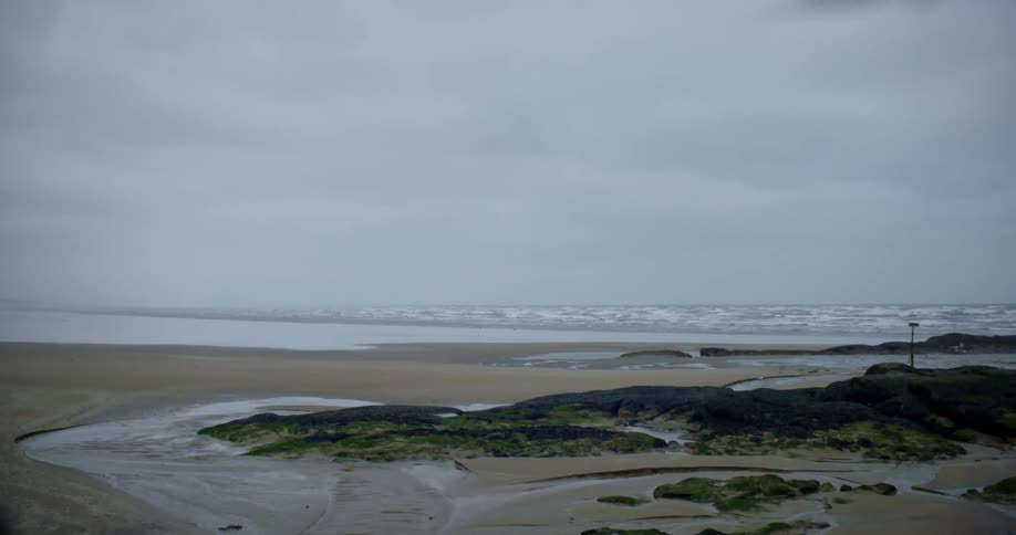 Waves rolling in to a sandy beach