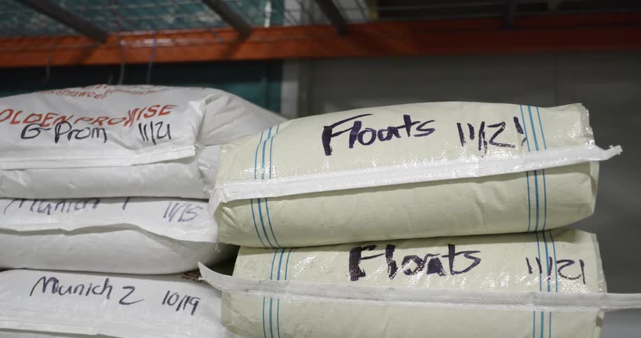 Sacks piled up on a rack inside a warehouse