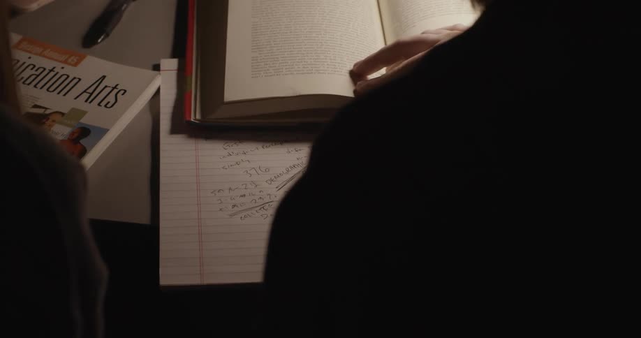 Two people studying with a book