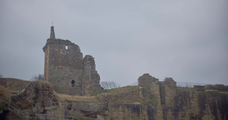Ruins of the cobblestone walls of a castle over a cliff