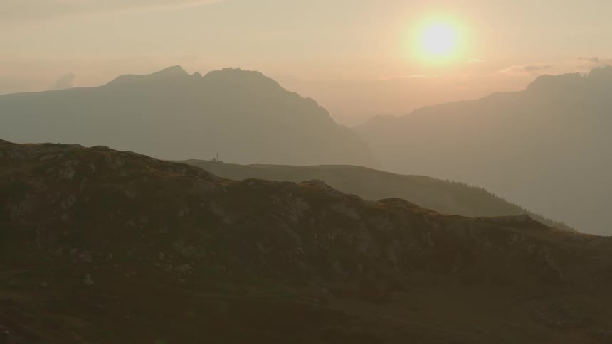 A landscape of hills at sunset