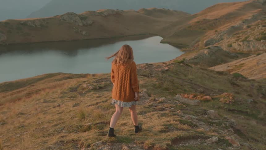 A woman walking down a hill