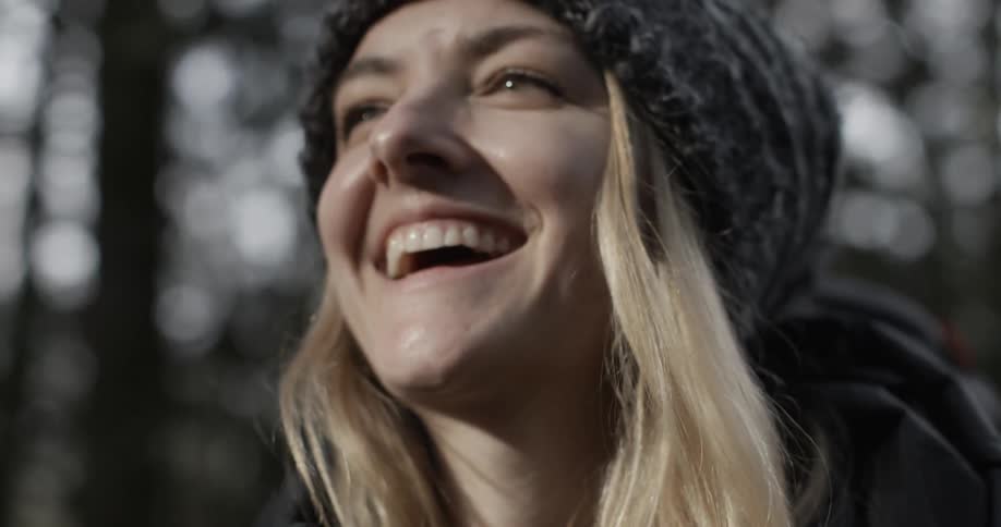 A woman smiling after taking a photograph