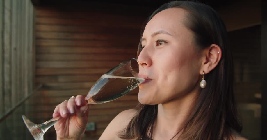 A woman is driving an alcoholic beverage
