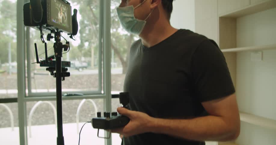 A man looks at images on a camera