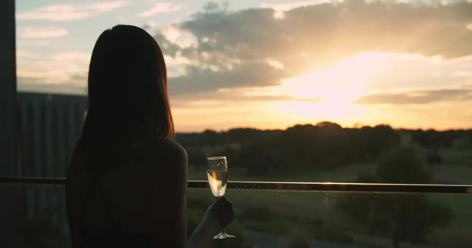 A woman looking off into the sunset