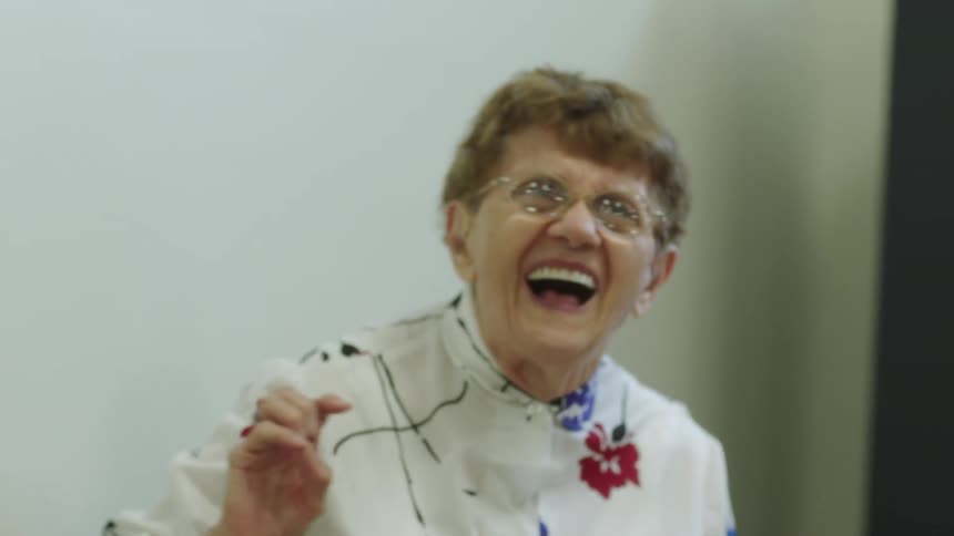 A woman laughs and talks with friends
