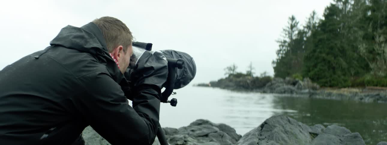A man taking a photo of a forest