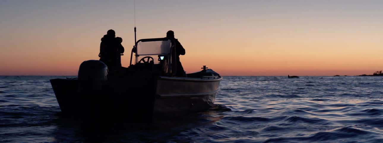 Two people taking photos on a boat