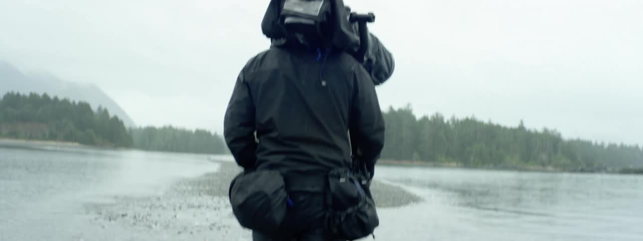 A man is walking through a lake