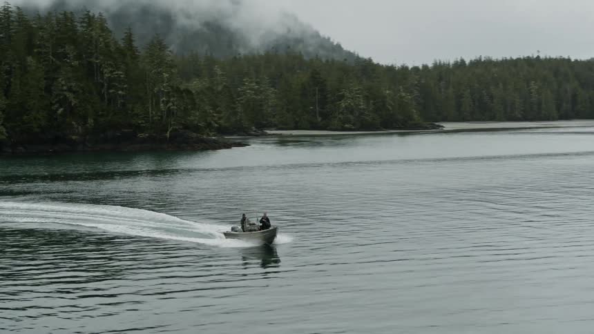 People are driving a boat on the lake in spring