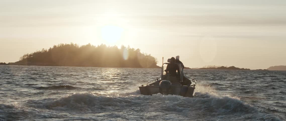 A boat driving down a lake