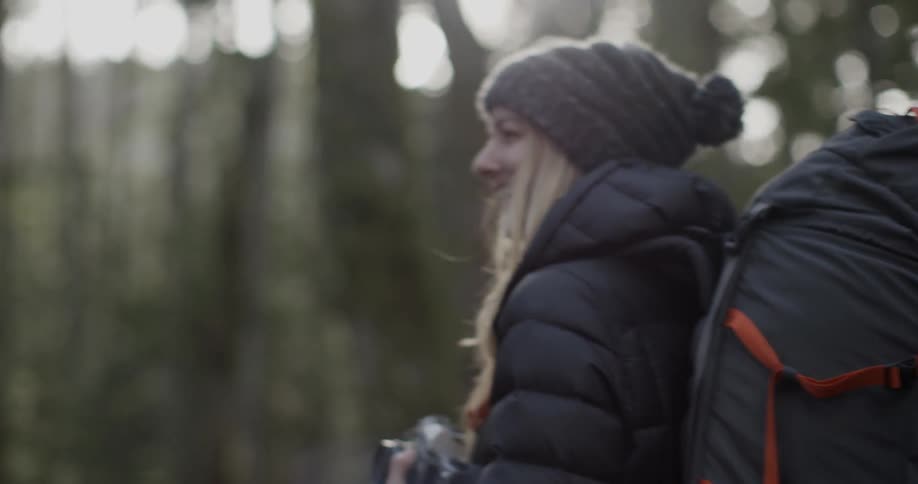Hikers talking and smiling in the woods