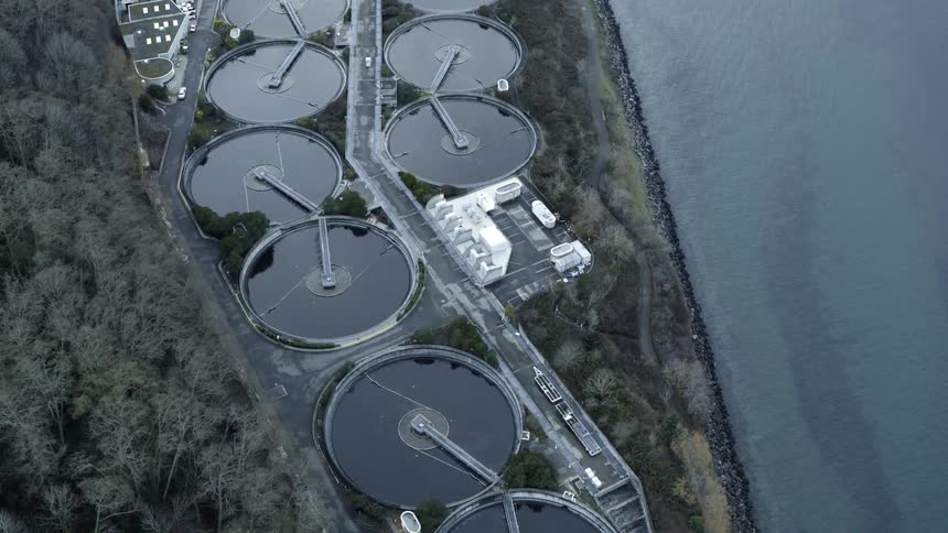 Top down tilt up of a wastewater treatment plant along an ocean shoreline
