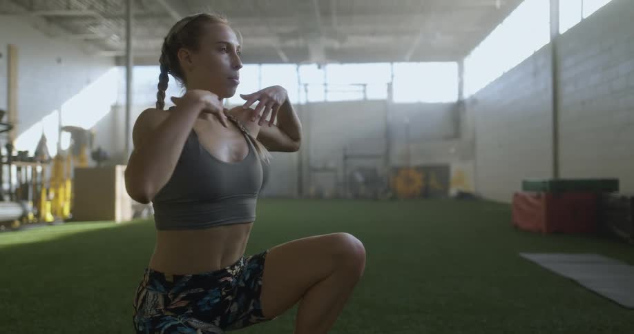 A fitness instructor demonstrates a stretch