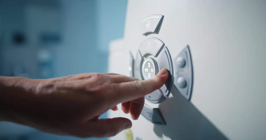A person pushing a button on a machine