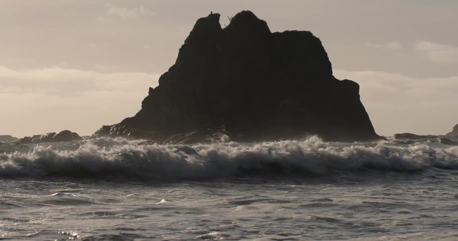 Ocean waves wash ashore at sunset
